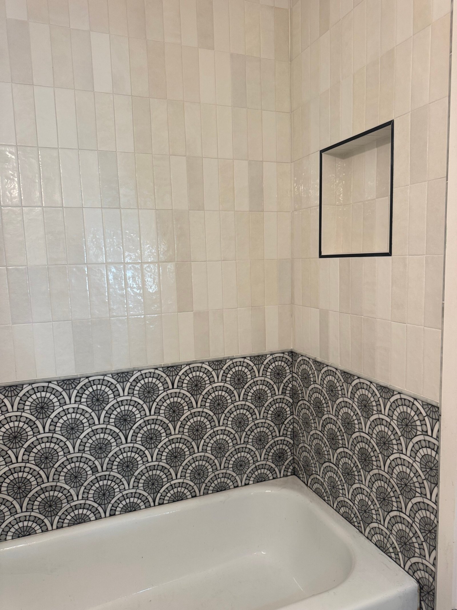 Patterned floor tile set against a stacked tile wall