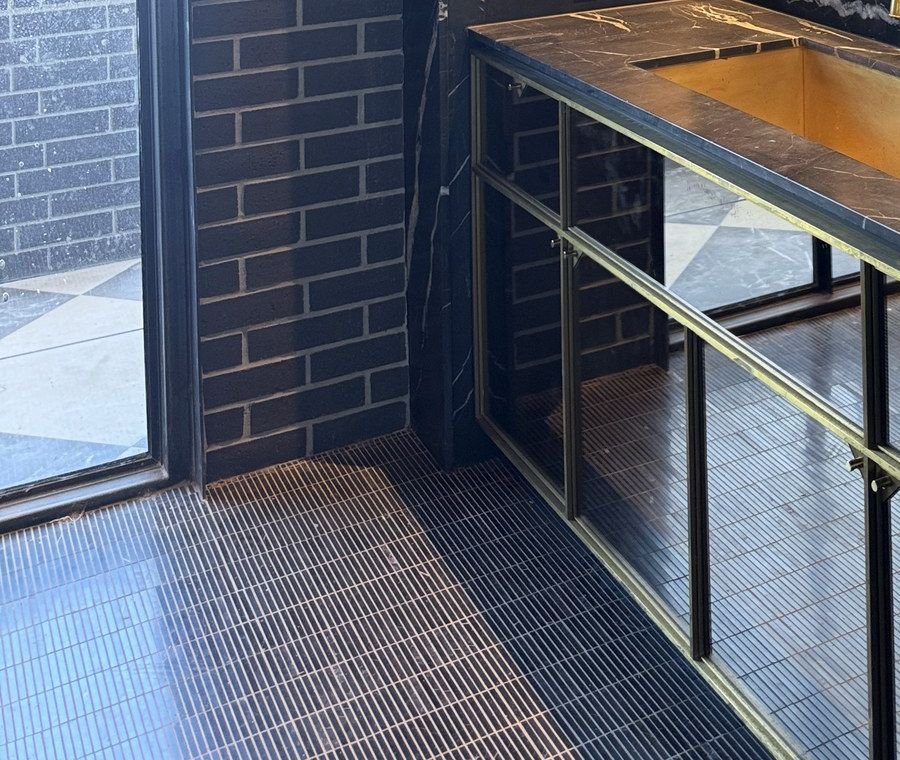 Dark tiled interior with a contrasting counter and cabinetry